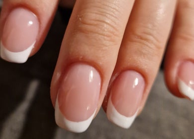 Elegant French manicure with glossy finish at Jennie's Gels & Beauty, Pencoed, Wales, GB.