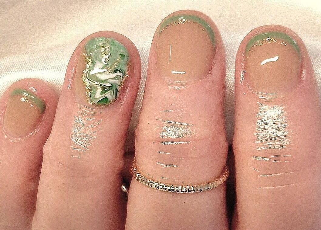 Intricate nail art in green and gold at The Salon at Westway, Marksbury, England, GB.