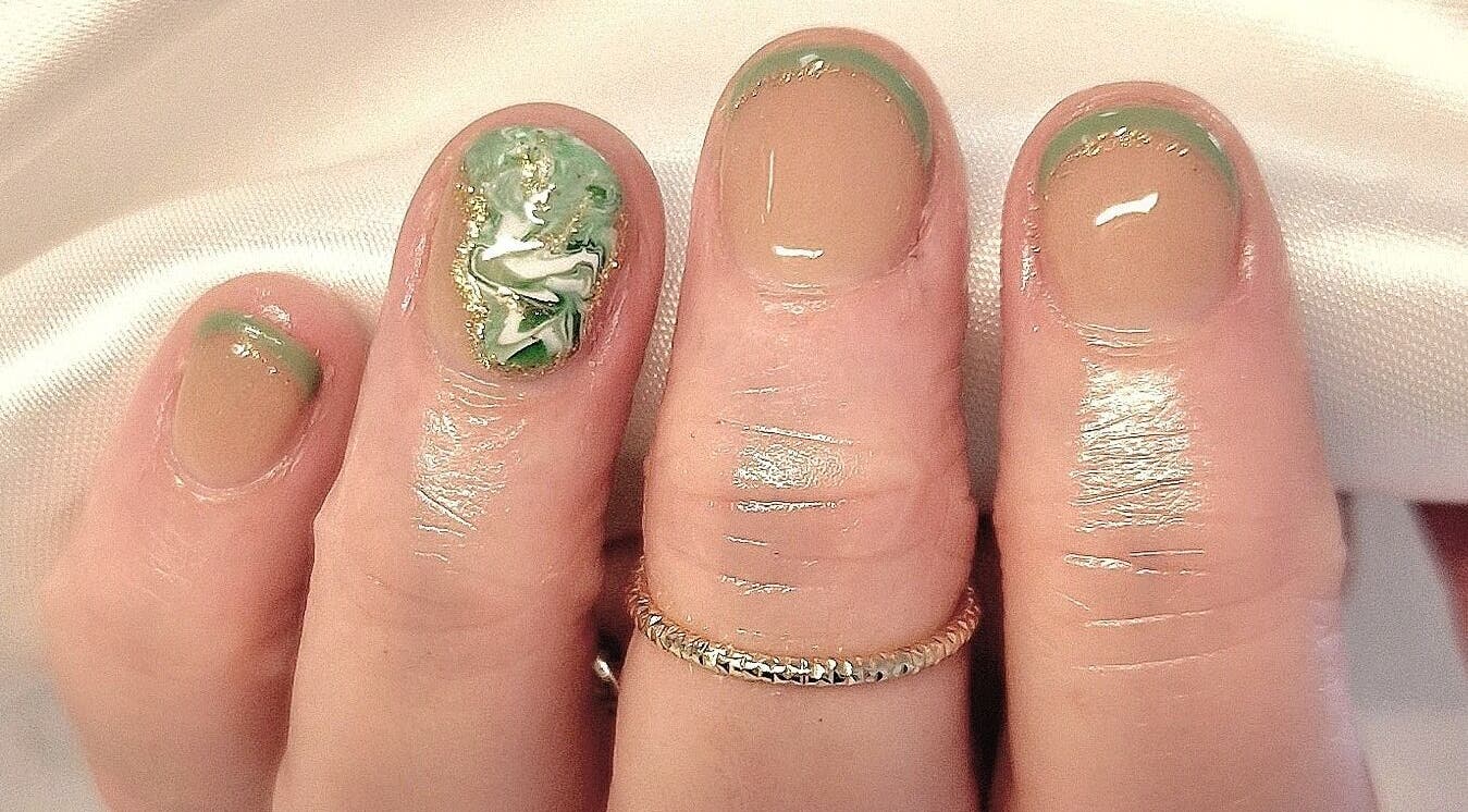 Intricate nail art in green and gold at The Salon at Westway, Marksbury, England, GB.