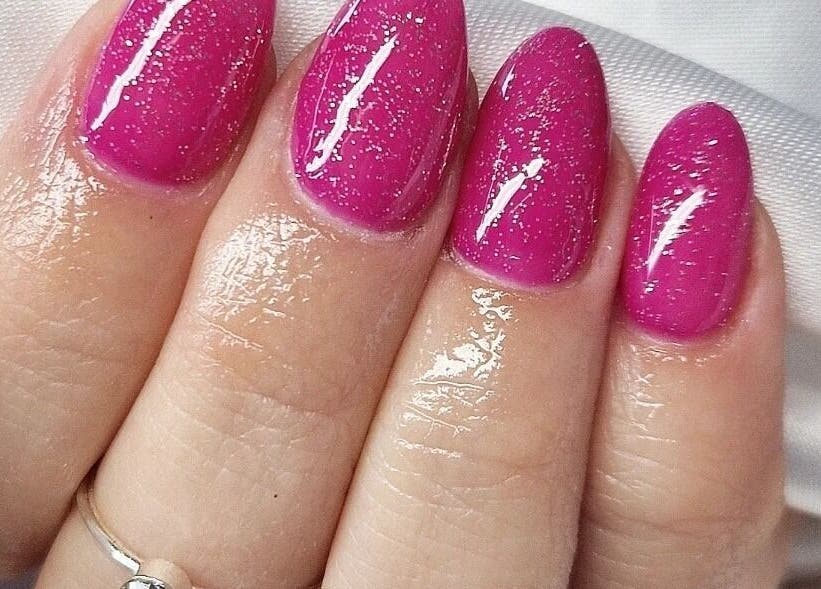 Vibrant pink glitter nails at The Salon at Westway, Marksbury, England, GB. Perfect for a sparkling style.