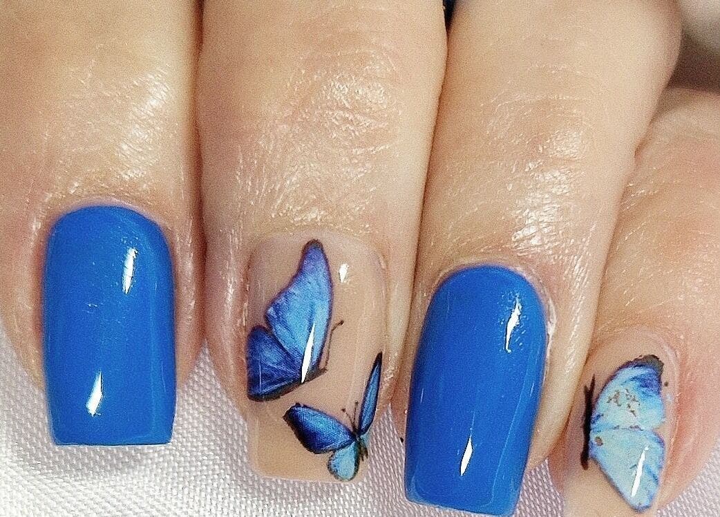 Vibrant blue and butterfly nail art at The Salon at Westway, Marksbury, England, GB.