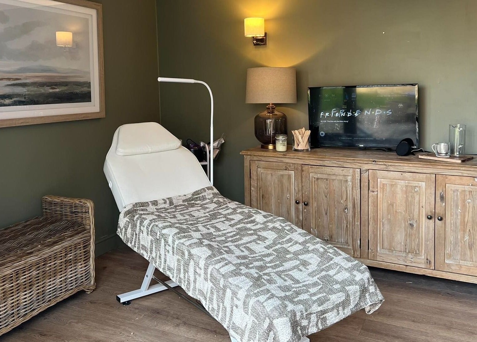 Cozy treatment room at The Wax Hut, Kinsham Tewkesbury, England, GB, with massage table and ambient lighting.