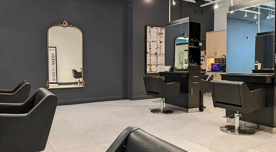 Spacious interior of Romeo Salon Kitchener, featuring stylish black chairs in Kitchener, Ontario, CA.