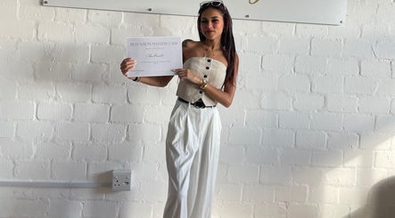 Individual holding a certificate at Clo Glo Studio in Cape Town, Western Cape, ZA, highlighting professional achievement.