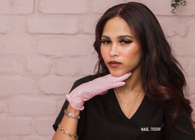 Nail technician at Clo Glo Studio in Cape Town, Western Cape, ZA, wearing a pink glove.
