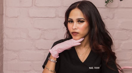 Nail technician at Clo Glo Studio in Cape Town, Western Cape, ZA, wearing a pink glove.