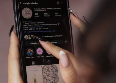 Close-up of a smartphone showing Clo Glo Studio's Instagram profile in Cape Town, Western Cape, ZA.