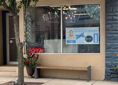 Front view of Meraki Beauty Studio in Canonsburg, Pennsylvania, US with an open sign and promotional poster.