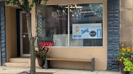 Front view of Meraki Beauty Studio in Canonsburg, Pennsylvania, US with an open sign and promotional poster.