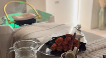 Relaxing spa setup at The Head Spa Uk in London, England, GB with roses, a cozy blanket, and a water pitcher.