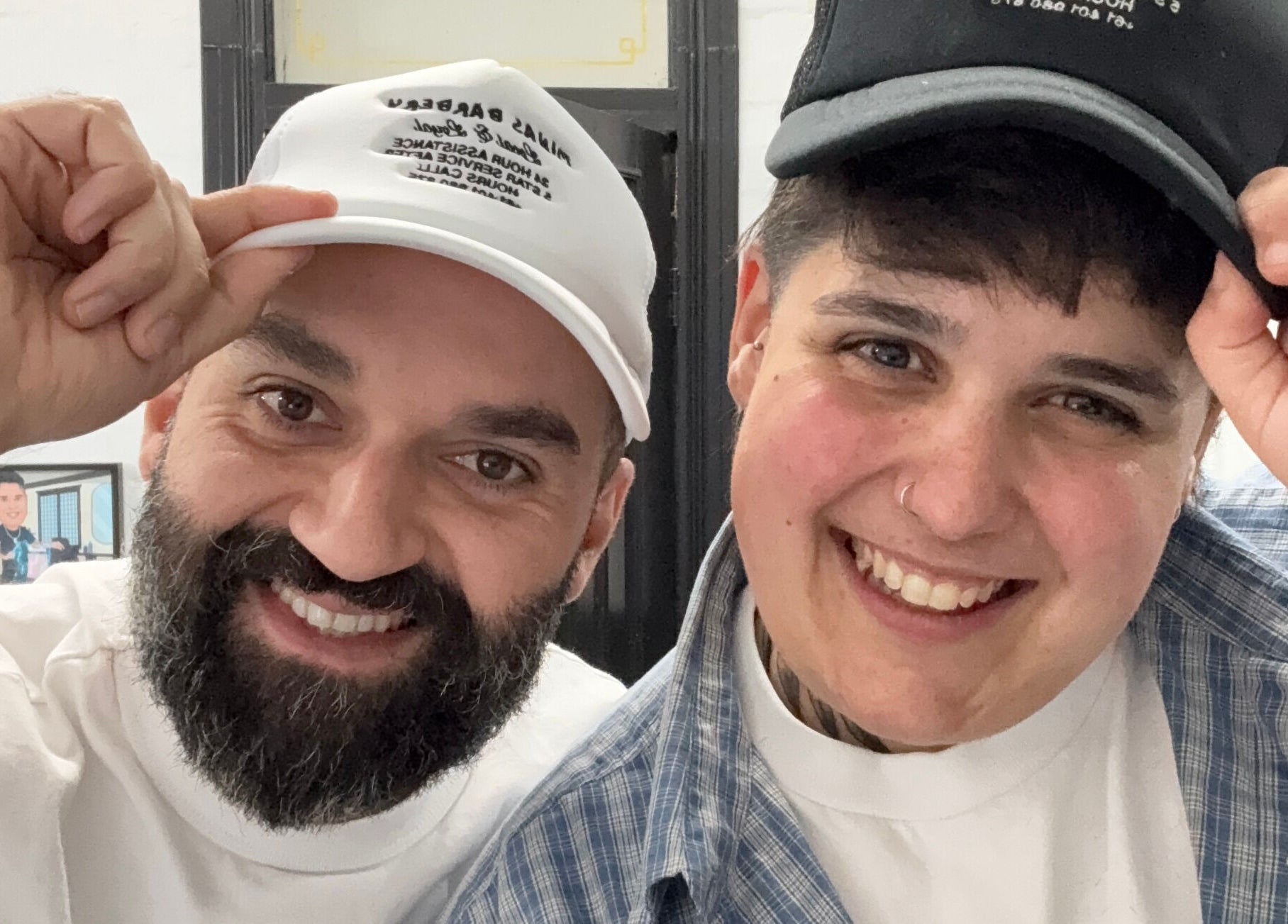 Two smiling people in hats at Minas Barbery, Enmore, New South Wales, AU.