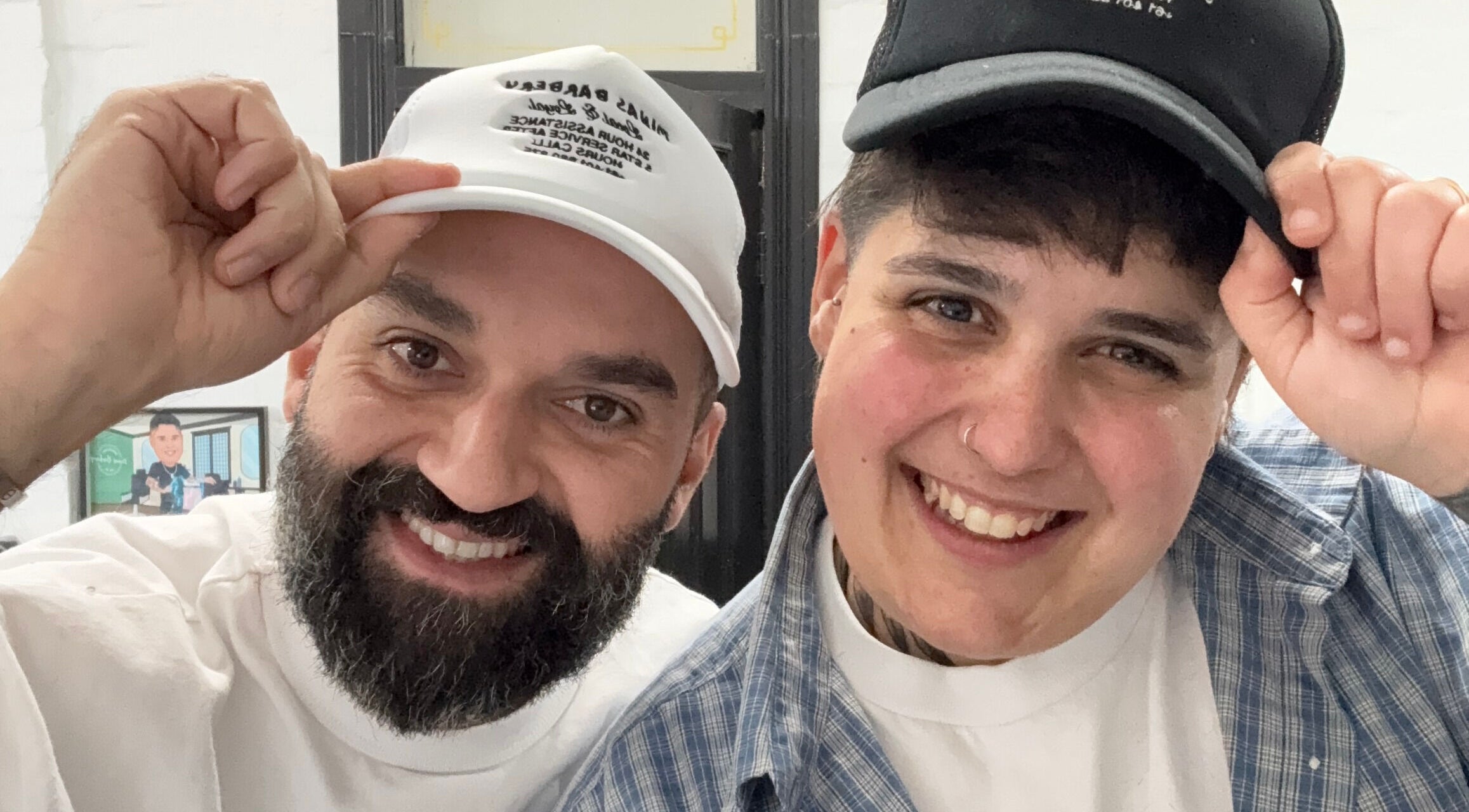 Two smiling people in hats at Minas Barbery, Enmore, New South Wales, AU.