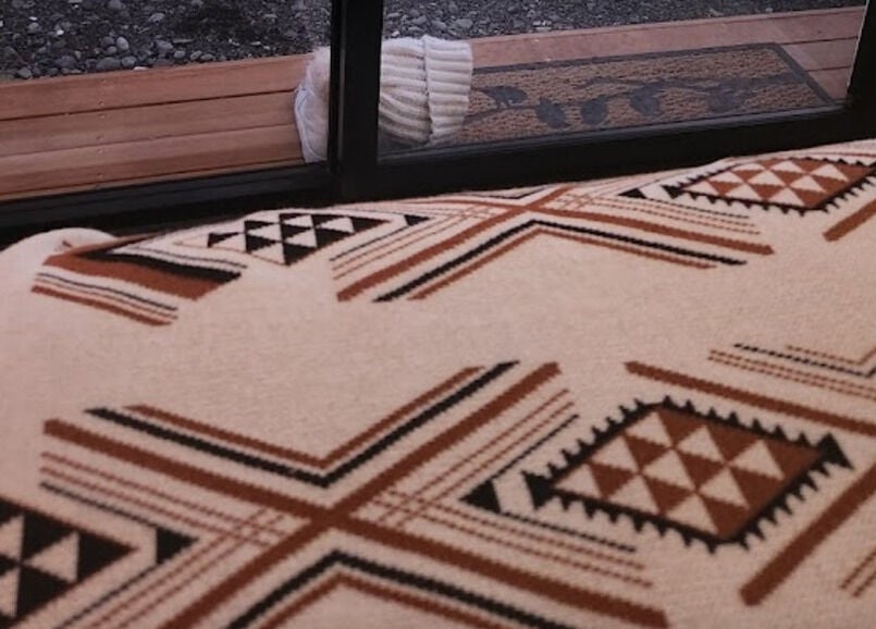 Kotiora venue's cozy interior featuring a patterned throw in Ōtaki, Wellington, NZ.