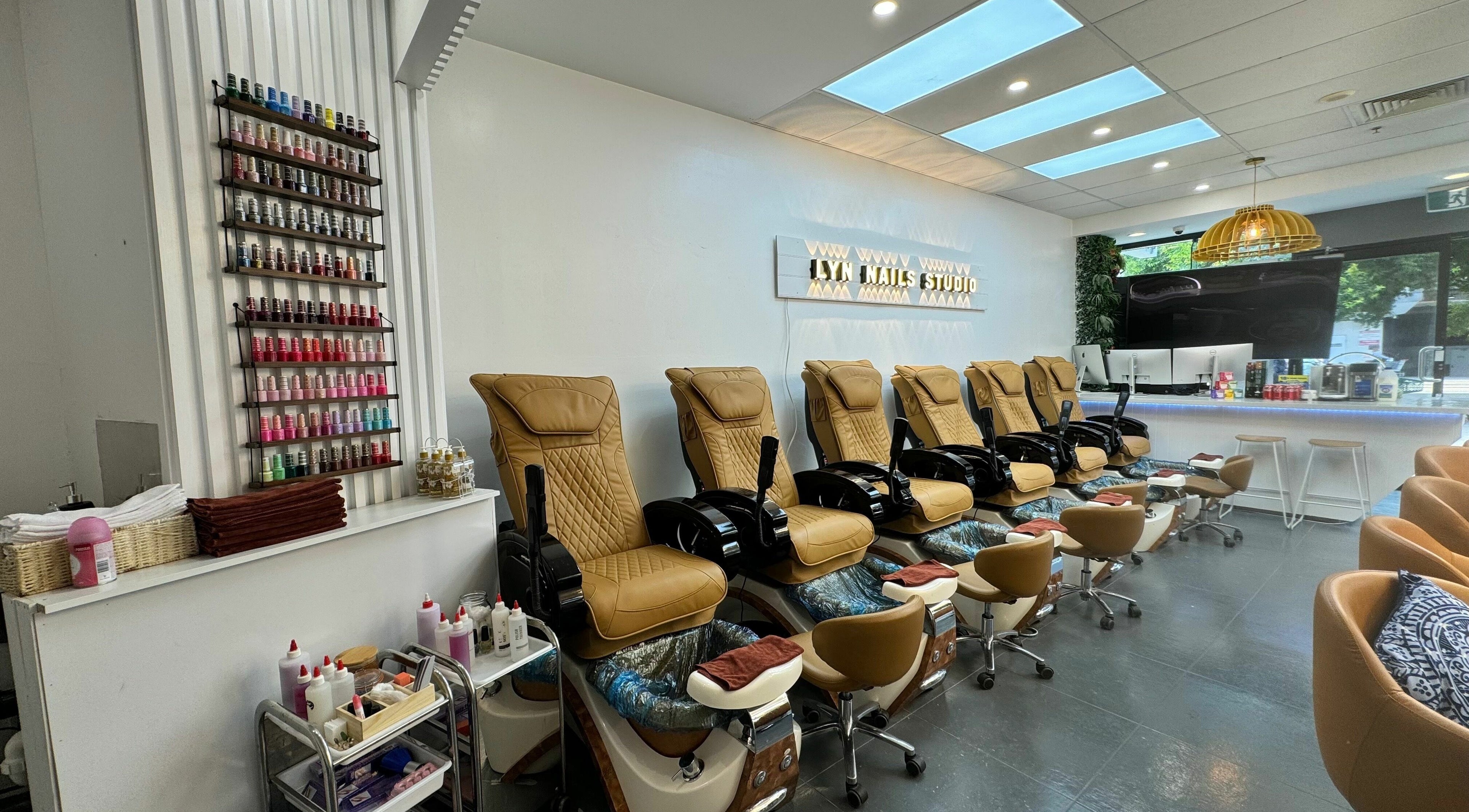 Luxurious nail spa chairs and polish display at LYN Nails Studio in Southport, Queensland, AU.