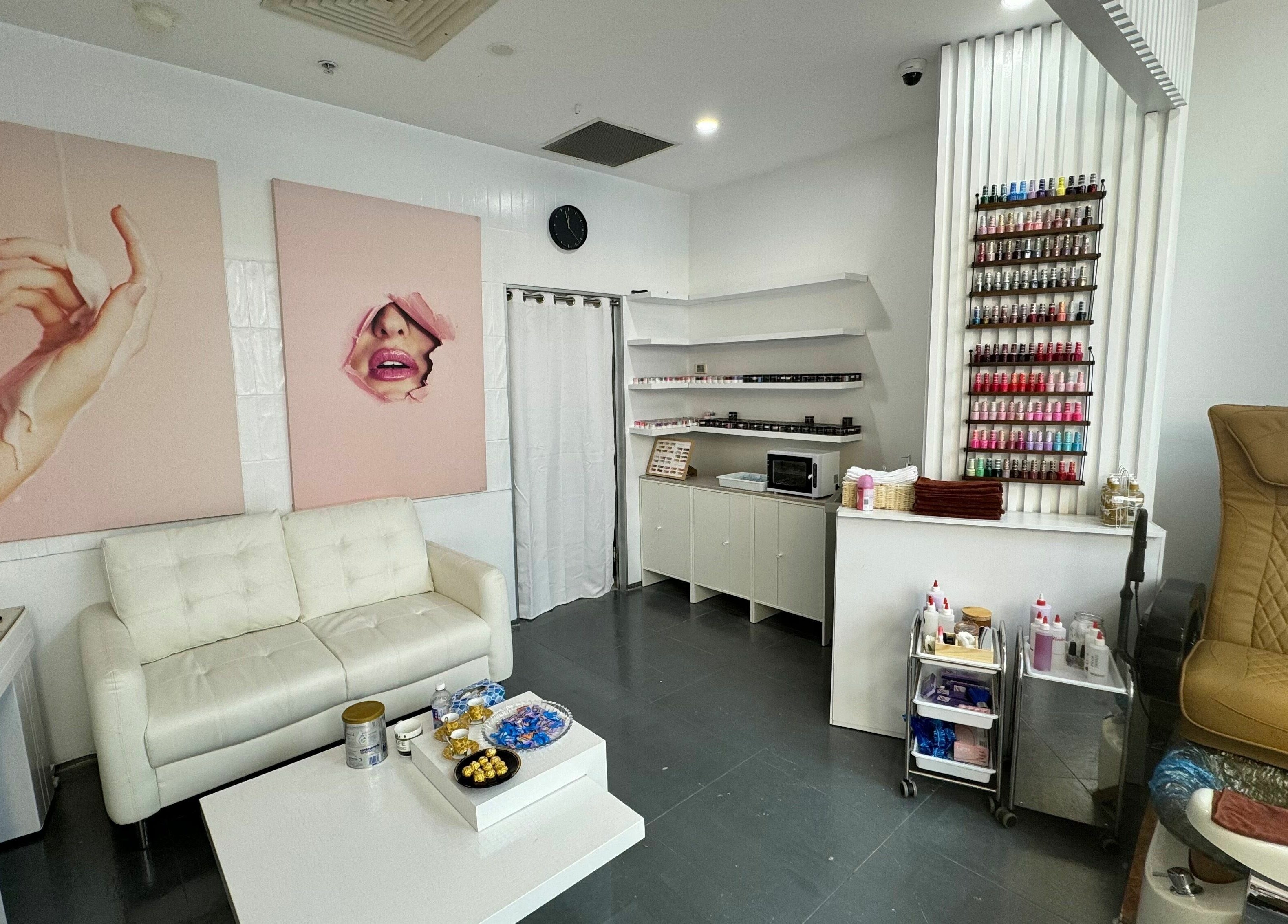 Stylish interior of LYN Nails Studio, Southport, Queensland, featuring a cozy waiting area and colorful nail polish display.