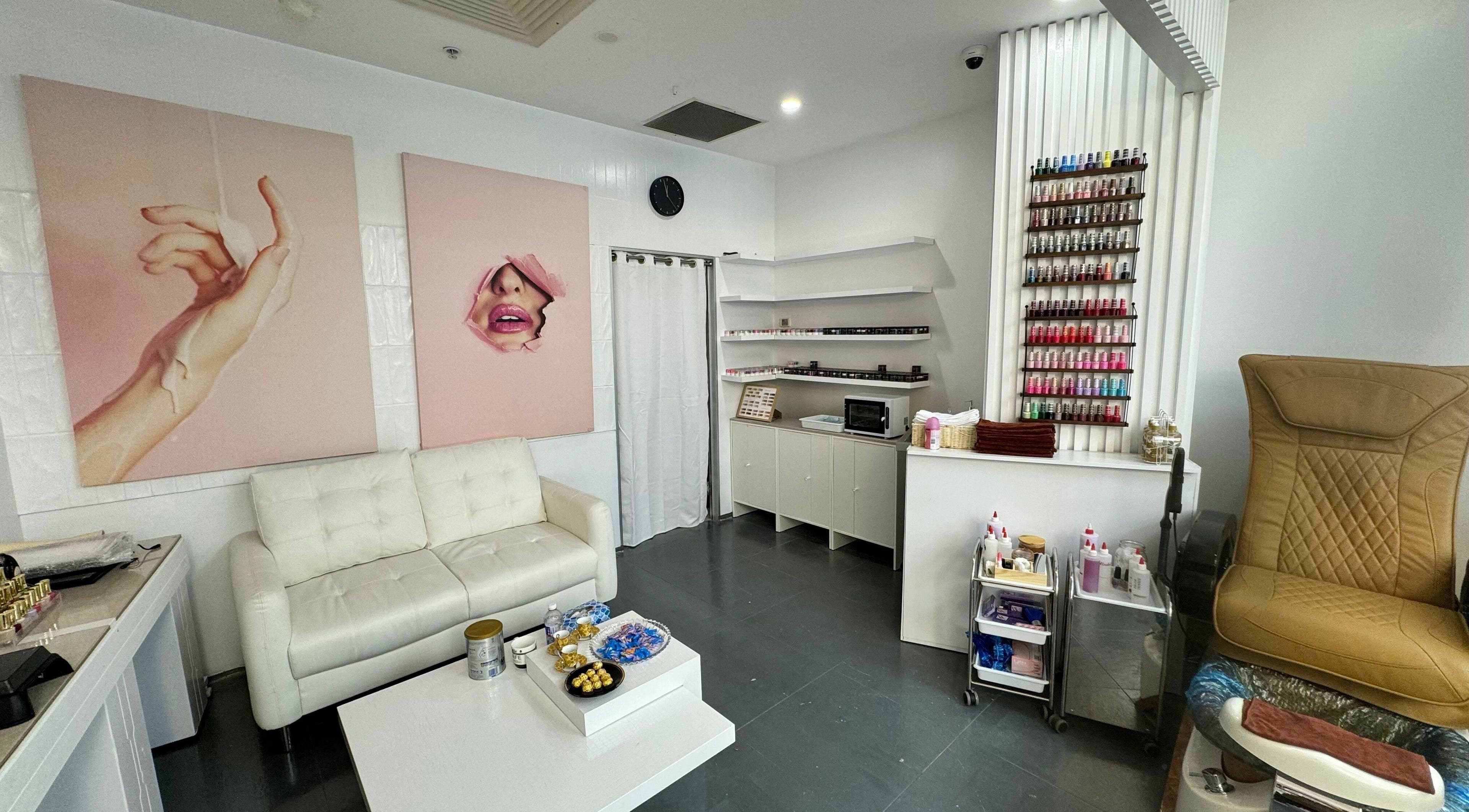Stylish interior of LYN Nails Studio, Southport, Queensland, featuring a cozy waiting area and colorful nail polish display.