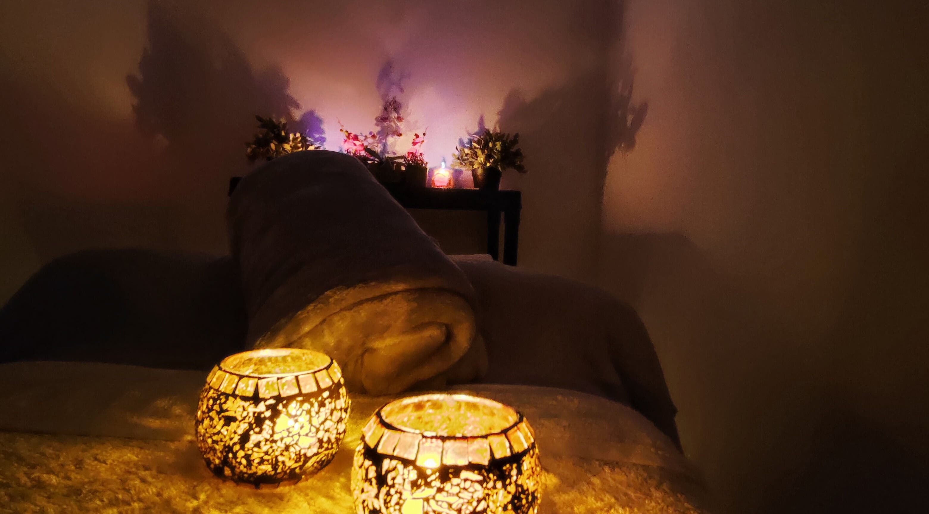 Cozy spa bed with glowing candles at Meraki Spa and Beauty Lounge, Paphos, IE.