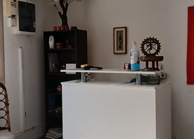 Reception desk at MoiThai Spa, Westville, Kwazulu-natal, ZA featuring elegant decor and artwork.