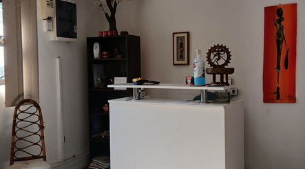 Reception desk at MoiThai Spa, Westville, Kwazulu-natal, ZA featuring elegant decor and artwork.