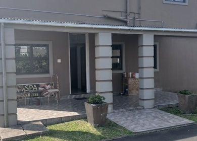 Charming entrance of MoiThai Spa in Westville, Kwazulu-natal, ZA with elegant columns and potted plants.