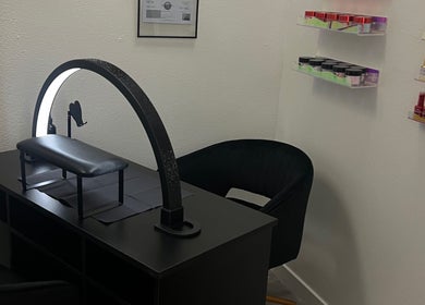 Modern nail station at Clawed and Polished, Redlands, California, US showcasing sleek design and product display.