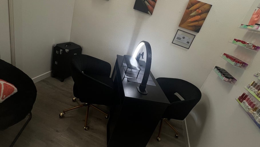 Modern nail station at Clawed and Polished, Redlands, California, US with curved chairs and organized polish shelves.