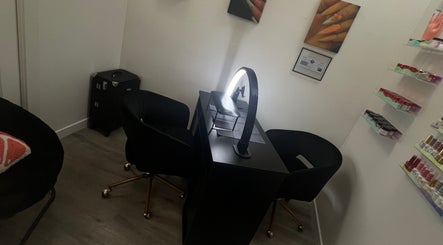 Modern nail station at Clawed and Polished, Redlands, California, US with curved chairs and organized polish shelves.