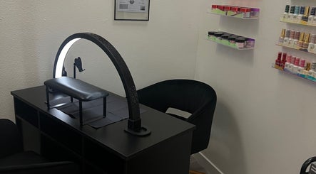 Modern nail station at Clawed and Polished, Redlands, California, US with nail polish shelves.