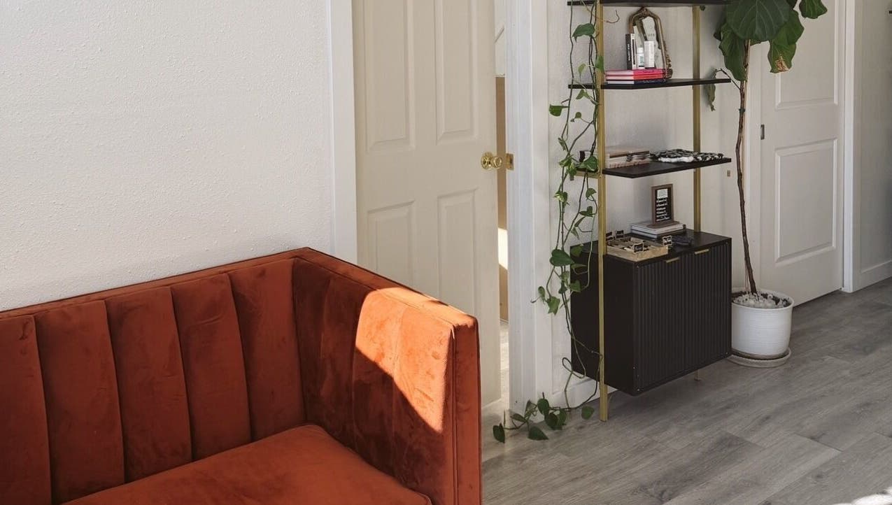 Elegant seating area at Clawed and Polished, Redlands, California, US with a plush sofa and decor.