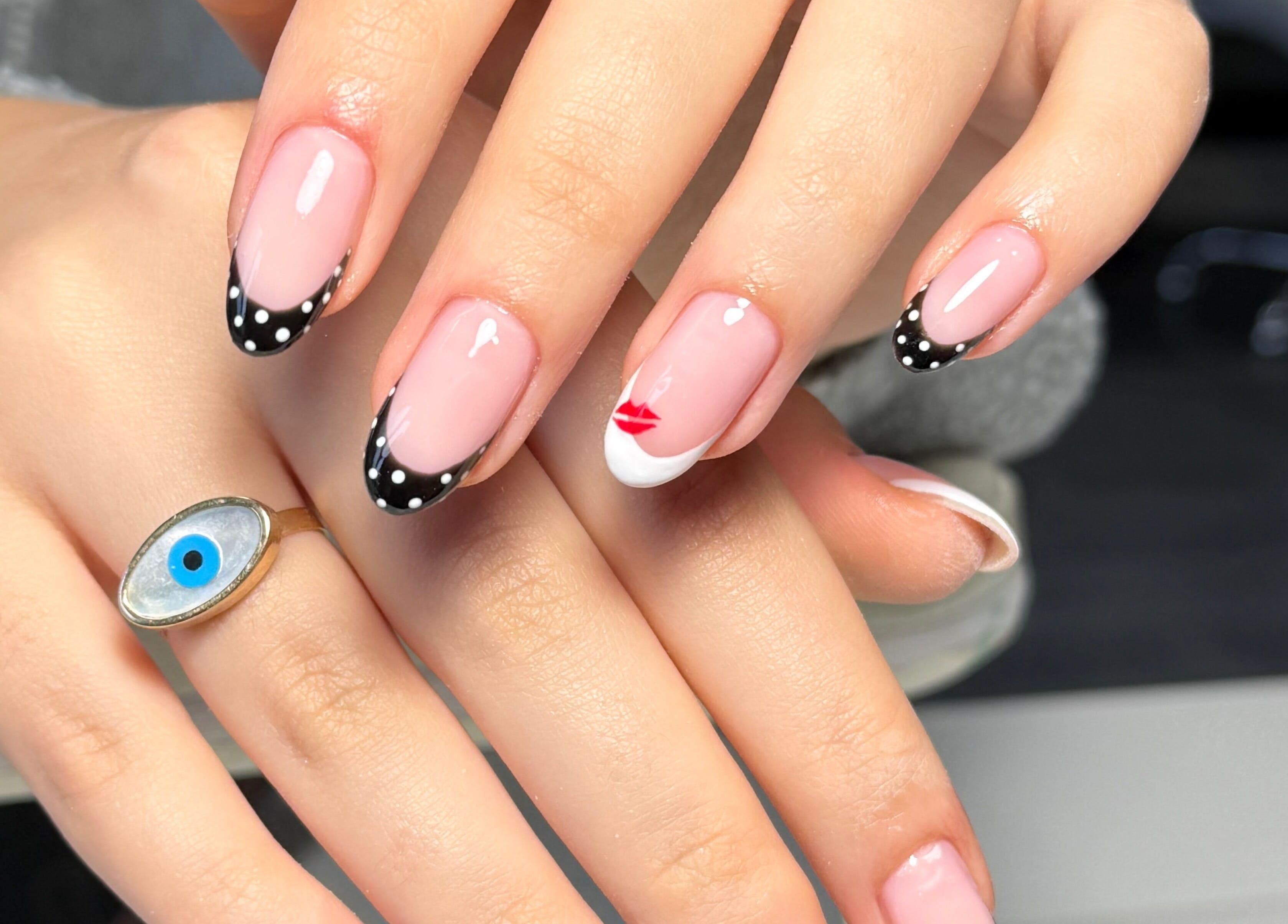 Elegant polka dot and lip nail design at Nails By Somy, Bredbury, England, GB.