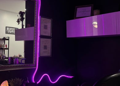 Stylish interior of NanoGlow Hair Co. in Fort Erie, Ontario, CA with purple lights and decor.