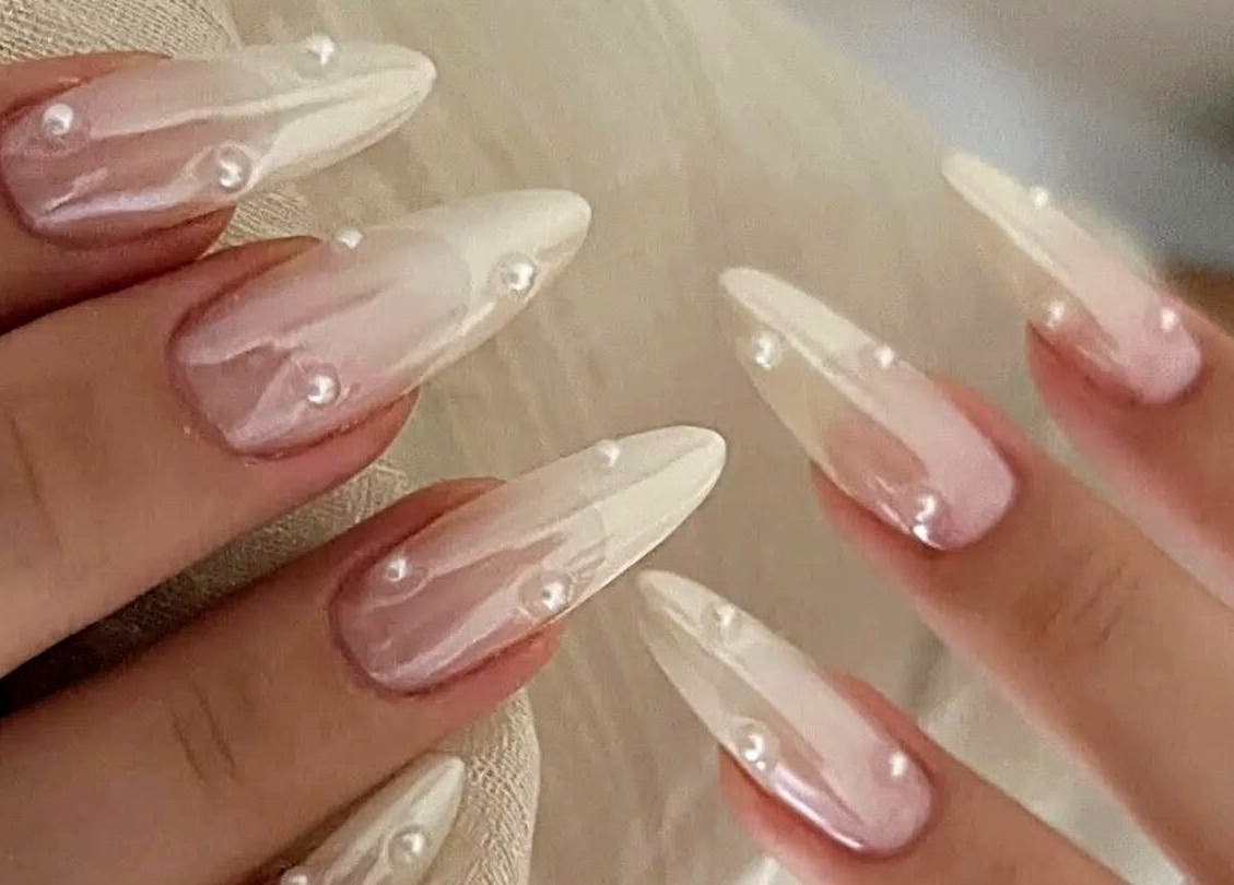 Elegant pearl-accented nails at Secret Butterfly Nails and Beauty, Sydney, New South Wales, AU.