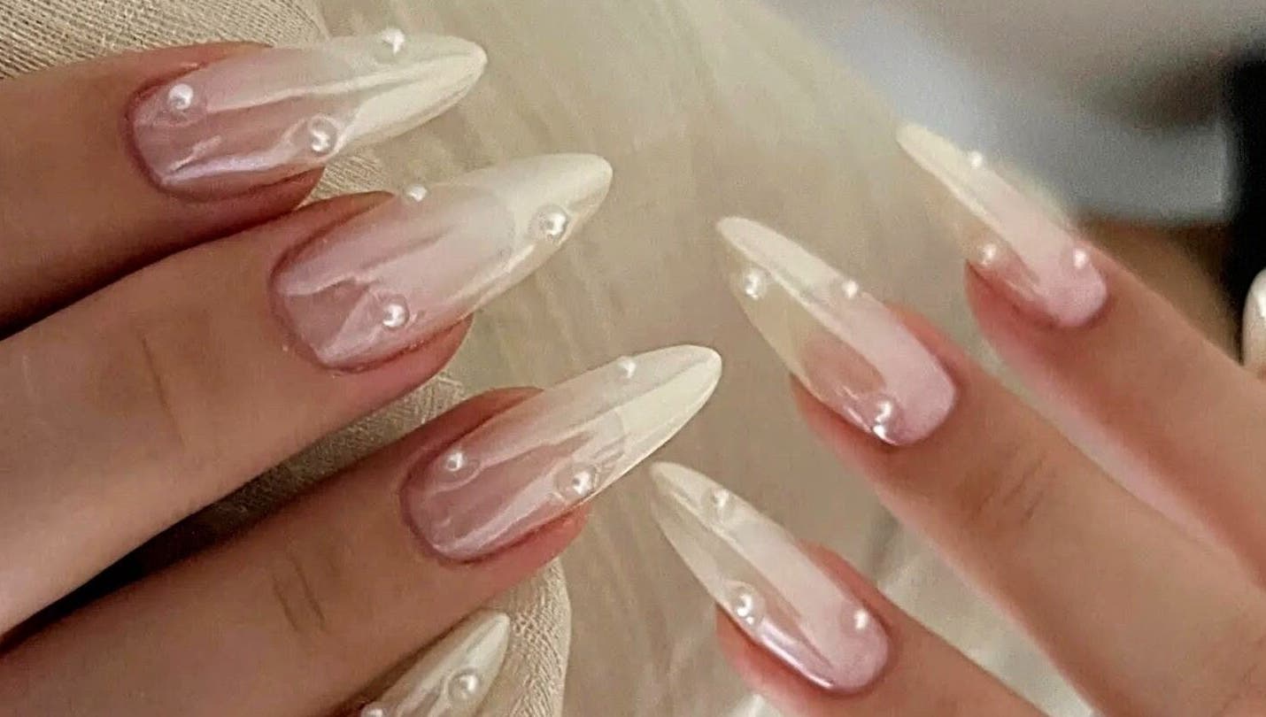 Elegant pearl-adorned nails at Secret Butterfly Nails and Beauty, Sydney, New South Wales, AU.