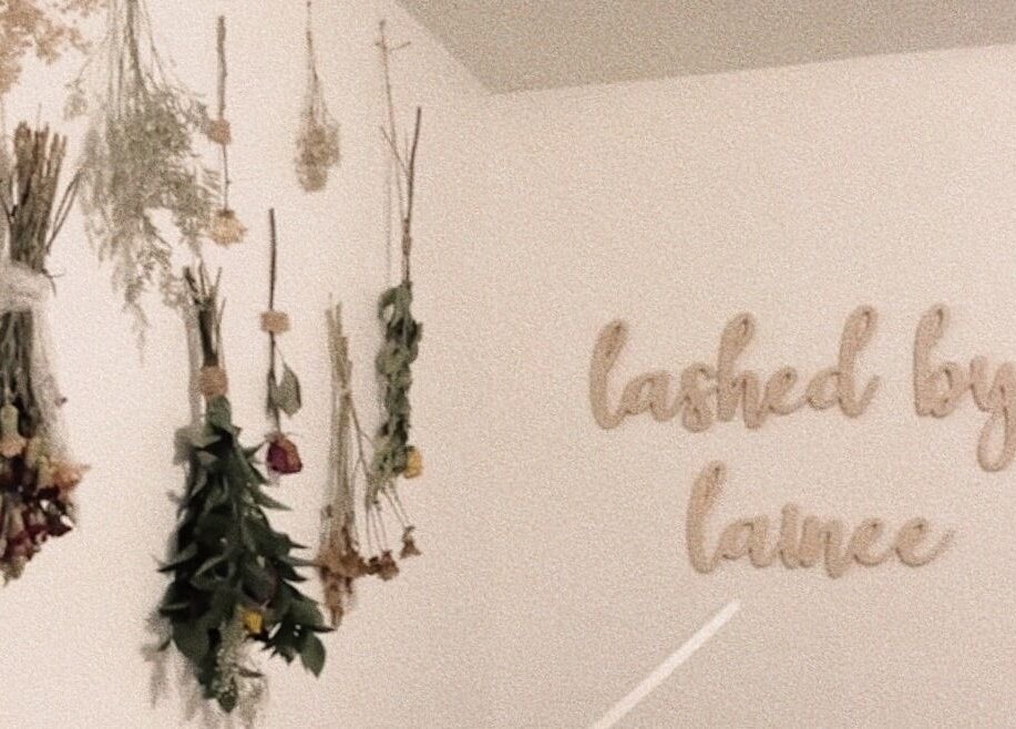 Dried flowers and 'lashed by lainee' sign at lovelylooksbylainee, Tooele, Utah, US, offering serene ambiance.