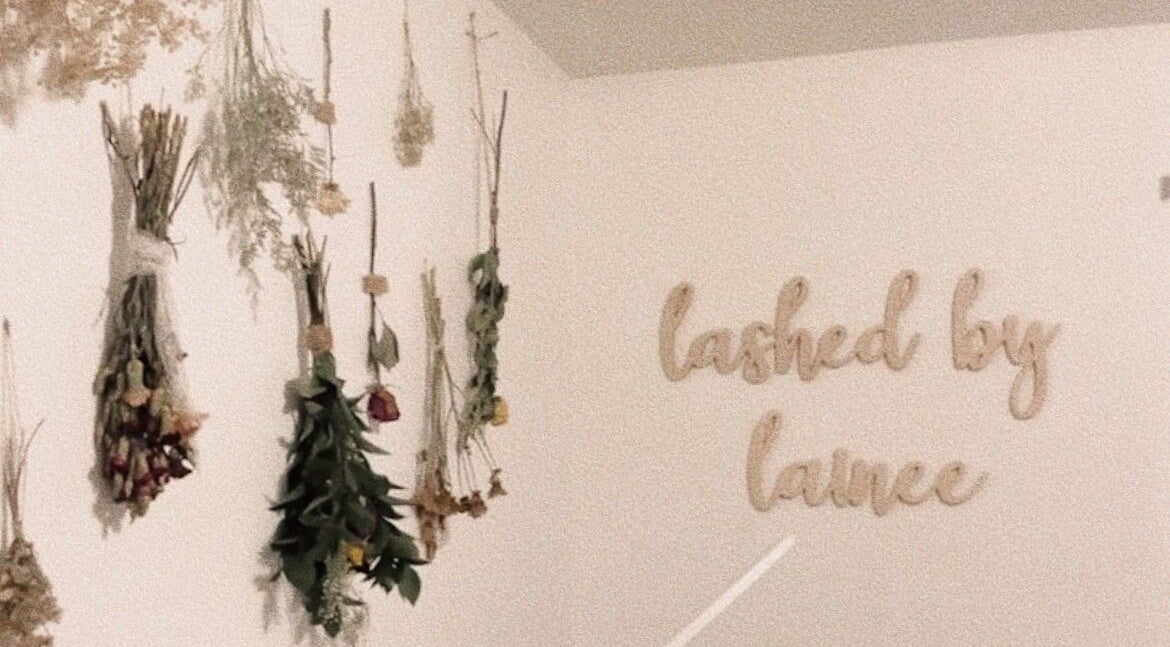 Dried flowers and 'lashed by lainee' sign at lovelylooksbylainee, Tooele, Utah, US, offering serene ambiance.