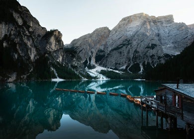 Tranquil mountain lake scene at KDC, Dasmariñas, Calabarzon, PH with reflections and rustic cabin.