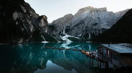 Tranquil mountain lake scene at KDC, Dasmariñas, Calabarzon, PH with reflections and rustic cabin.