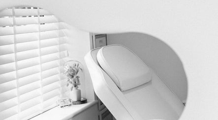 Relaxing treatment chair at MW Clinic in Whitehill, England, GB with soothing decor and soft lighting.