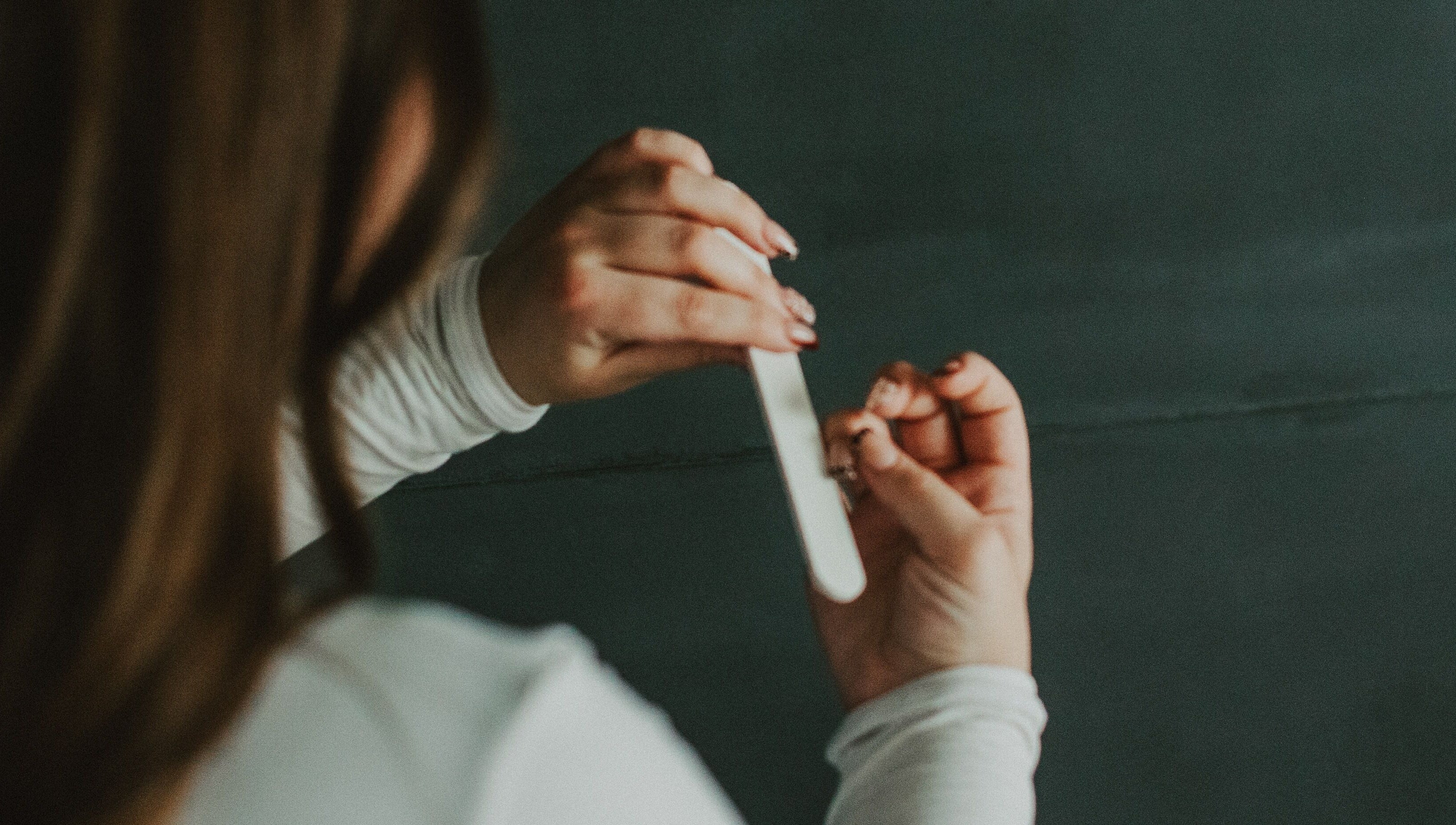 Nail filing service at Nails by cj, Spruce Grove, Alberta, CA, showcasing professional care.