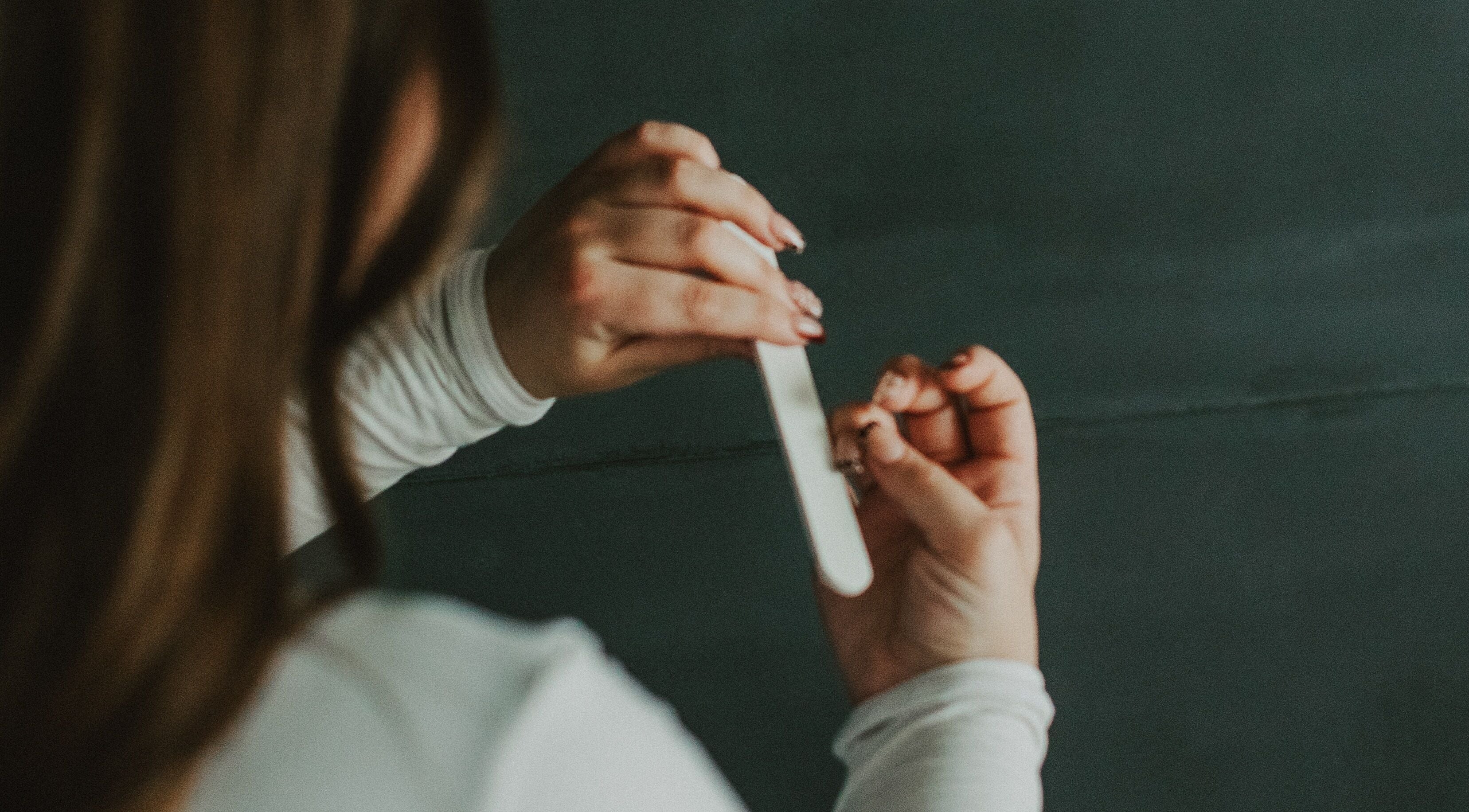 Nail filing service at Nails by cj, Spruce Grove, Alberta, CA, showcasing professional care.