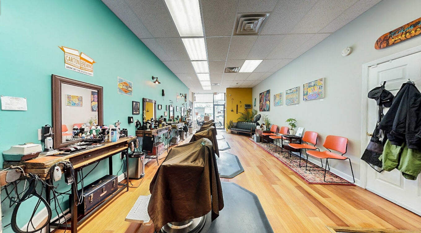 Interior of Talking Heads Barber Shop in Asbury Park, New Jersey, US, showcasing chic decor and barber chairs.