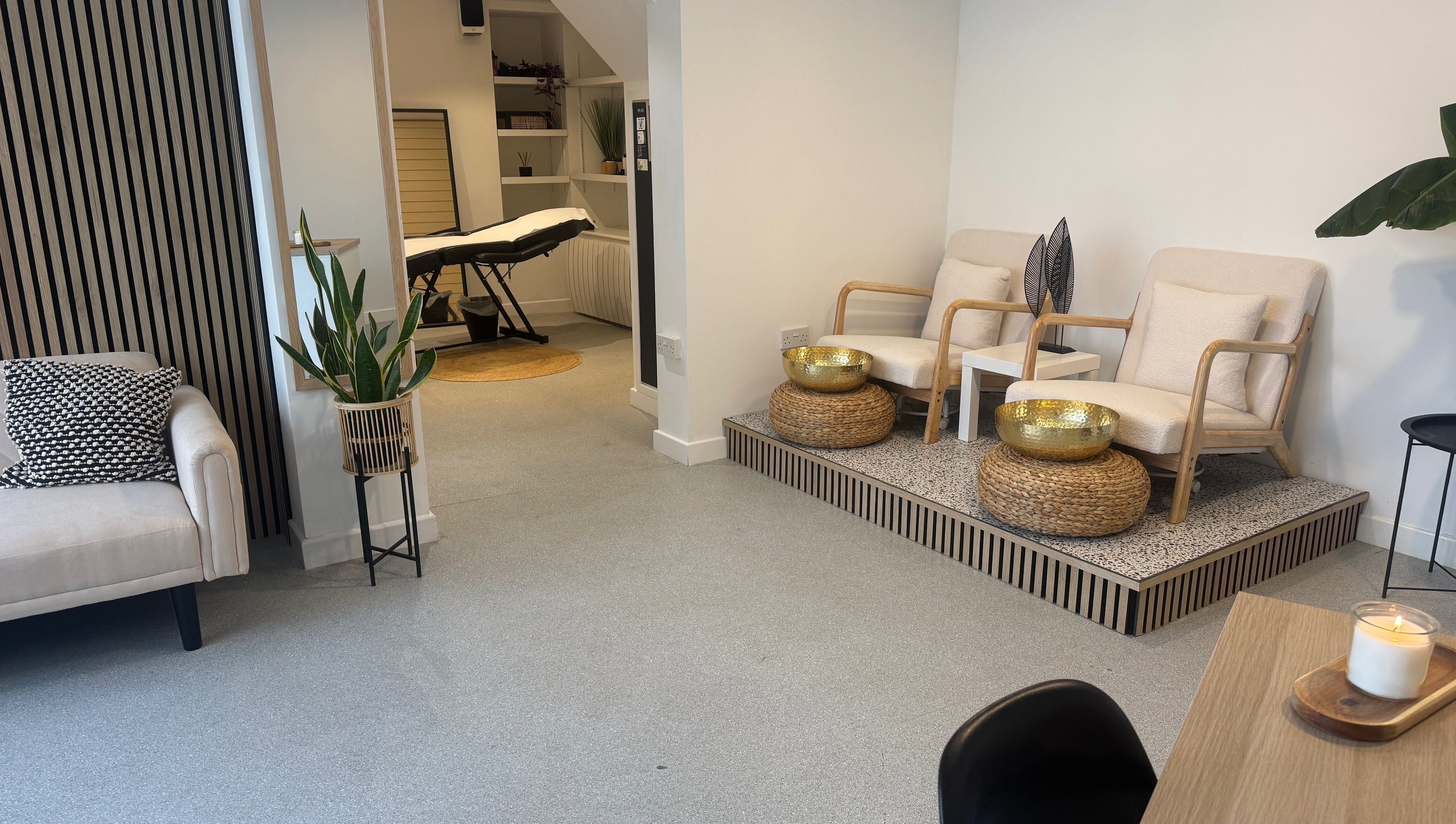 Relaxing waiting area at Muse Beauty + Wellness, Weymouth, England, GB, featuring modern seating and decor.