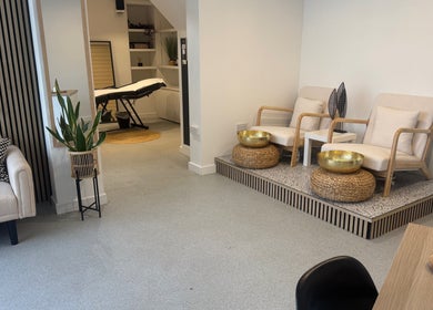 Relaxing waiting area at Muse Beauty + Wellness, Weymouth, England, GB, featuring modern seating and decor.