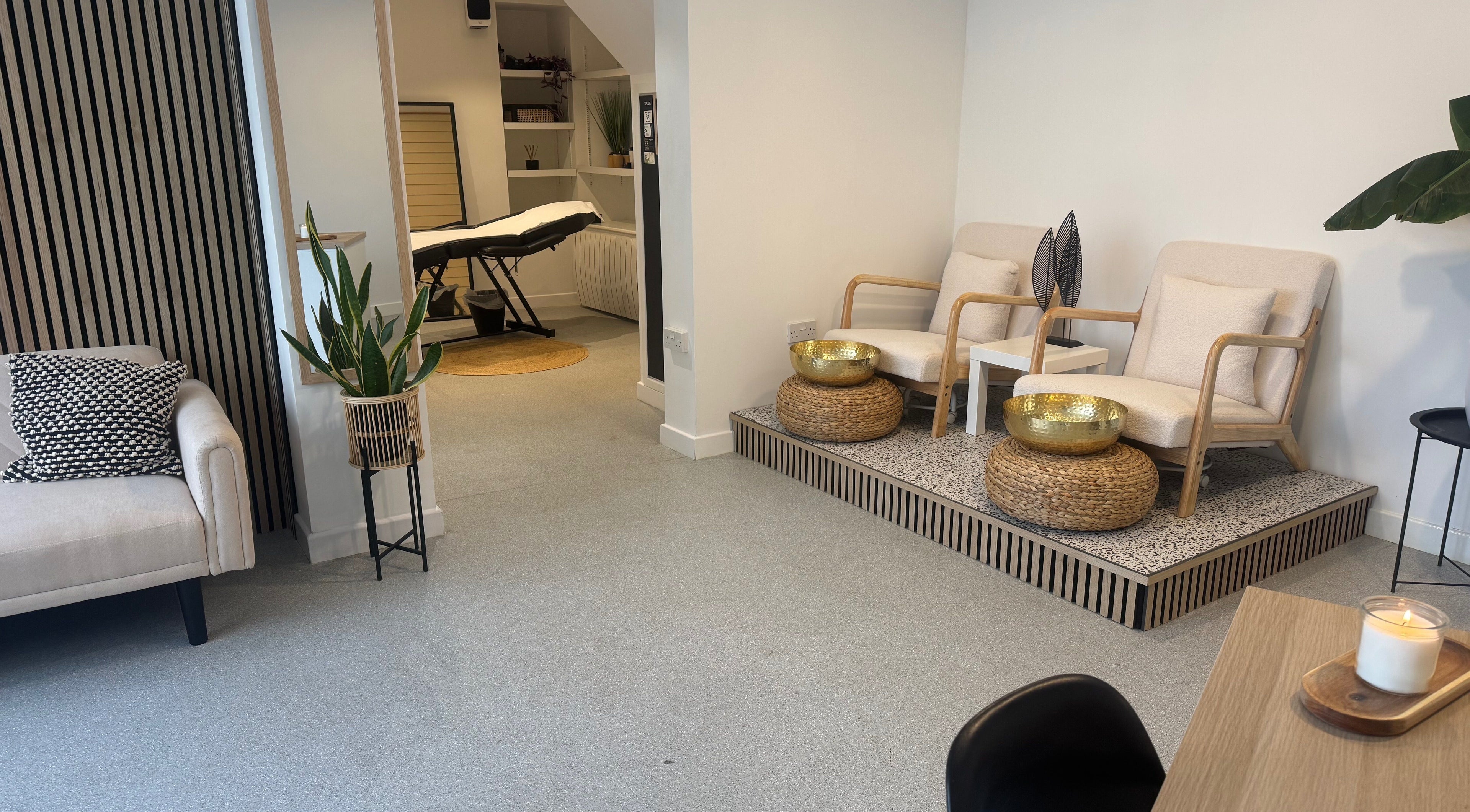 Relaxing waiting area at Muse Beauty + Wellness, Weymouth, England, GB, featuring modern seating and decor.