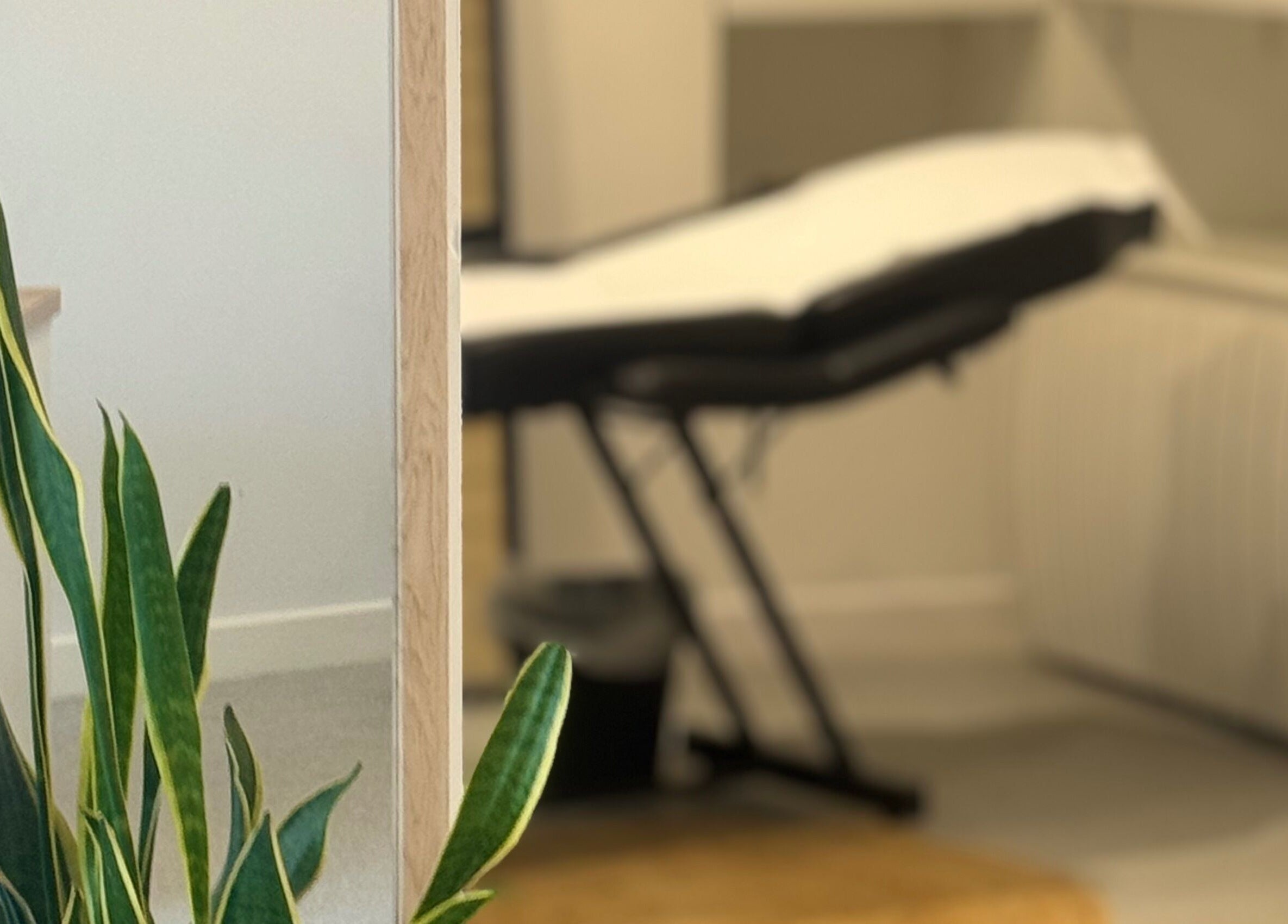 Relaxing therapy room at Muse Beauty + Wellness, Weymouth, England, GB with a comfortable treatment bed.