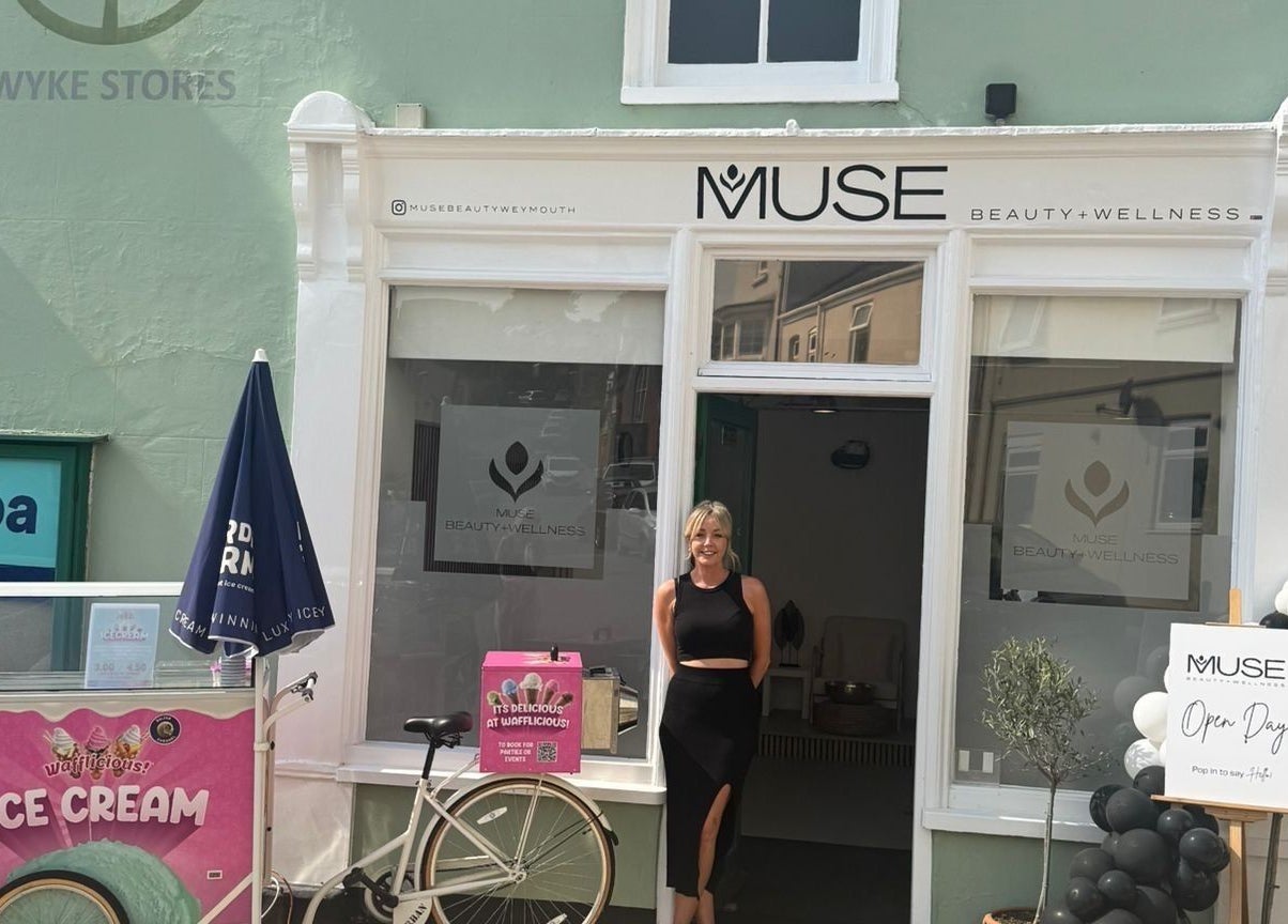 Entrance of Muse Beauty + Wellness in Weymouth, England, with staff welcoming guests.