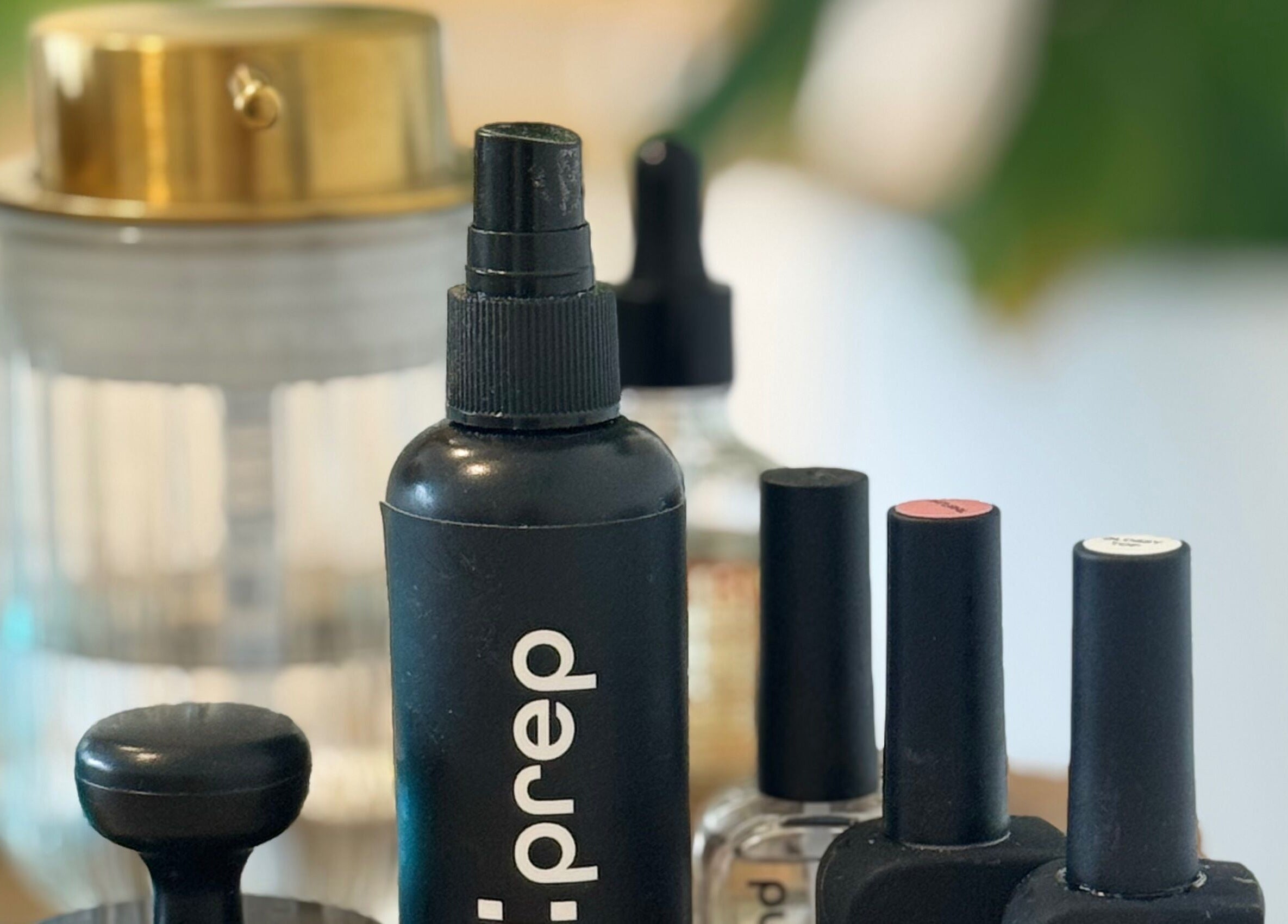 Beauty products at Muse Beauty + Wellness, Weymouth, England, GB, including nail polish and spray bottle.