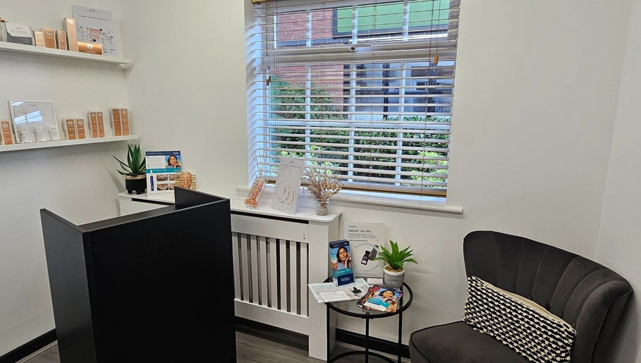 Cozy reception at DermaDivine Skin Rejuvenation, Tamworth, England, GB, featuring skincare displays and a plush chair.