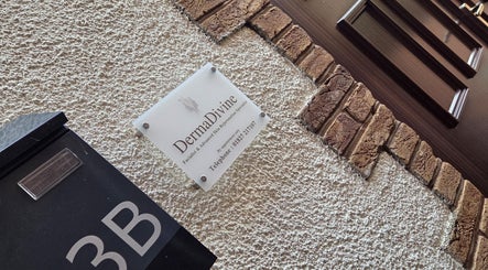 Exterior sign of DermaDivine Skin Rejuvenation, Tamworth, England, GB on a textured wall.