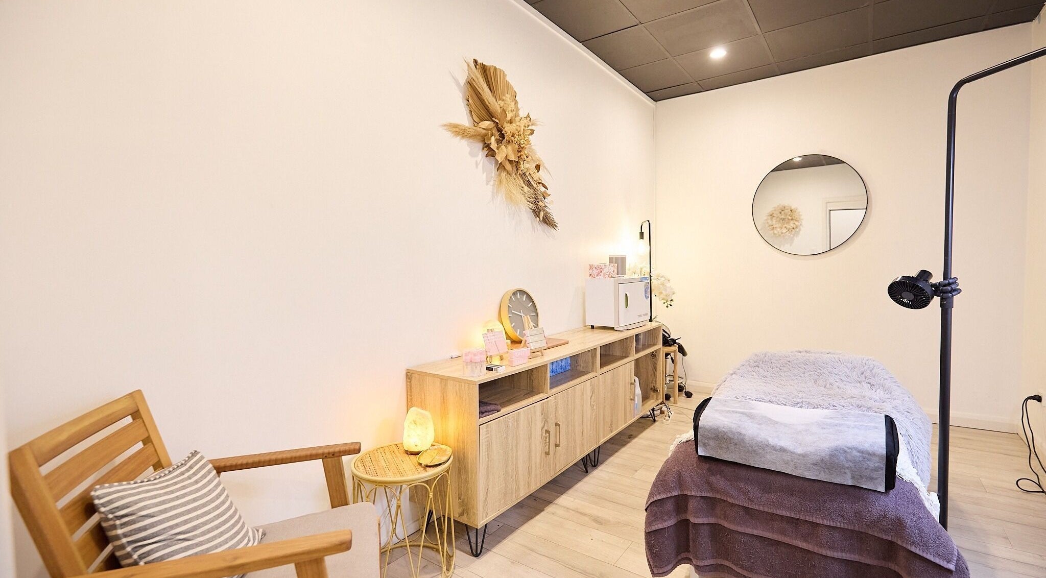 Lash Bar S tranquil treatment room at Bondi Junction, New South Wales, AU with a cozy bed and elegant decor.